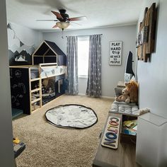 a child's bedroom with a bunk bed and playroom in the corner for toys