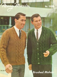 two men in sweaters and ties standing next to each other