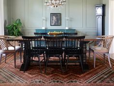 a dining room table with chairs and a chandelier