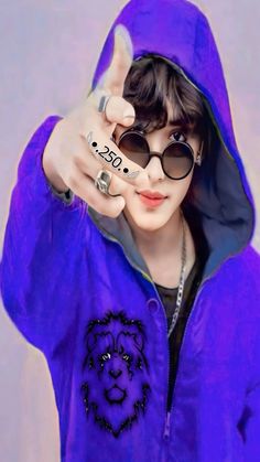 a person wearing sunglasses and a purple hoodie pointing to the side with their finger