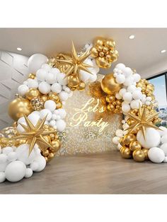 an arch made out of gold and white balloons