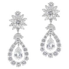 Van Cleef & Arpels Pear Shape Diamond Dangling Earrings made in Platinum. The total weight of the diamonds is appx. 15.15 carats of E-F color and VVS clarity diamonds. There are pear-shaped diamonds, surrounded by round diamonds, and with marquise-shaped diamonds all throughout. There is a polishing receipt from Van Cleef & Arpels. The length is 1⅞ inches. Signed and numbered. The pendants are detachable, and measure 1¼ inches, the earring top measures ⅝ inch. The two large pear shaped diamonds weigh appx. 2.20 and 2.15 carats of E-F color, VVS-VS clarity. 20.73 grams. Luxury Brilliant Cut Pear-shaped Cluster Earrings, Luxury Pear-shaped Diamond White Cluster Earrings, Luxury White Gold Chandelier Earrings Pear-shaped, Diamond Dangling Earrings, Luxury Pear-shaped Chandelier Earrings With Diamond Accents, White Pear-shaped Chandelier Earrings In Fine Jewelry, Dig Jewelry, Diamond Chandelier Earrings, Pear Earrings