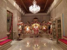 a man sitting in the middle of a room with chandelier and other decorations