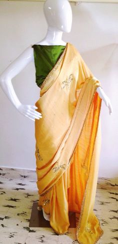 Sunny yellow semi silk saree with sequin and bead hand embroidered dragonflies with dark oilve green Festive Yellow Raw Silk Pre-draped Saree, Yellow Traditional Wear With Mirror Work In Tissue Silk, Elegant Yellow Saree With Mirror Work, Tussar Silk Traditional Wear With Mirror Work, Green Tissue Silk Blouse Piece With Gota Work, Green Silk Saree With Gota Work, Gold Pre-draped Chanderi Saree With Gota Work, Green Raw Silk Saree With Gota Work, Yellow Chanderi Saree With Mirror Work