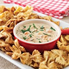 a white plate topped with chips and dip