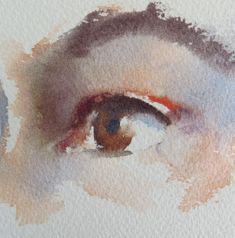 an eye is painted in watercolor on white paper with brown and red details around the iris