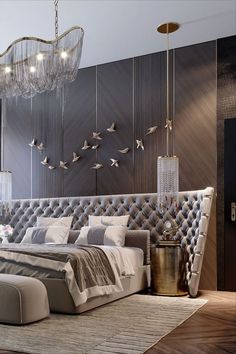 a large bed sitting under a chandelier in a bedroom