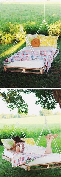 a woman laying in a hammock on top of a green grass covered field