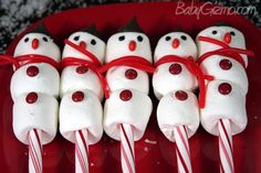 marshmallows are wrapped in red and white candy canes to look like snowmen