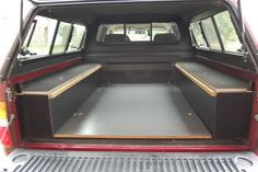 the back end of a red truck with its cargo compartment open and two doors opened