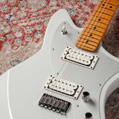 an electric guitar sitting on top of a carpet