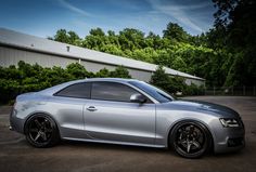 a silver car parked in front of a building