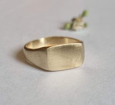 Classic pinky signet ring in a rectangular design, dainty minimalist ring jewelry for women, available in 14k gold plating, sterling silver, and in 9k solid yellow gold.  This delicate handmade gold ring is elegant and minimalist. It was made by carving wax and casting it into metal.  It is available in high-quality 14k gold plating over brass, 14k gold plating over sterling silver, sterling silver and in 9k or 14k solid yellow gold.  This ring is very comfortable to wear and great for everyday Dainty Recycled Gold Promise Signet Ring, Dainty Everyday Signet Ring In Recycled Gold, Everyday Dainty Signet Ring In Recycled Gold, Simple Gold Engraved Promise Ring, Modern Rectangular Signet Ring For Promise, Modern Rectangular Signet Promise Ring, Dainty Recycled Gold Signet Ring For Wedding, Minimalist Engraved Gold Ring In Recycled Gold, Simple Gold Signet Ring For Everyday