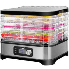 the food dehydrator is full of fresh fruits and vegetables