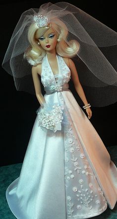 a barbie doll wearing a wedding dress and veil