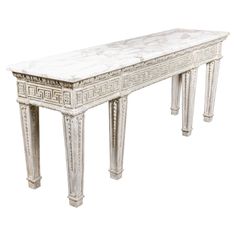 an antique white marble console table with intricate carvings on the top and sides, isolated against a white background