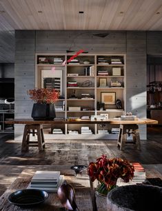 a living room filled with lots of furniture and bookshelves next to each other