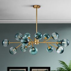 Elevate your space with the enchanting allure of this 15-light gradient blue bubble glass chandelier. Perfect for those who love a blend of modern design and artistic elegance, this chandelier features striking gradient blue glass globes that create a mesmerizing visual effect. The 41-inch diameter of the fixture ensures it becomes the centerpiece of any room, while the compact 9-inch height makes it suitable for spaces with lower ceilings. Customize the hanging height with adjustable rods, incl Glass Globe Chandelier, Mobile Chandelier, Lighted Branches, Unique Chandeliers, Bubble Chandelier, Inspire Me Home Decor, Globe Chandelier, Sputnik Chandelier, Gold Chandelier