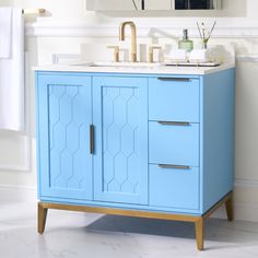 a bathroom with a blue cabinet and sink