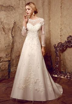 a woman in a white wedding dress posing for the camera with her hand on her face