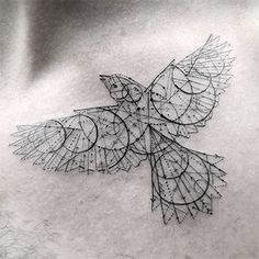 the back of a man's chest with an intricate bird tattoo on his chest