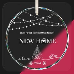 a glass ornament that says, our first christmas in our new home