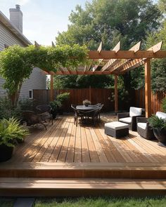 a wooden deck surrounded by plants and furniture