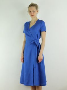 "Write the selected color in the message Handmade blue bayou wrap dress with short sleeves, 2 pockets and belt , perfect for casual wear and suitable for any occasion in any season Details: - 100% natural linen produced in Europe ; - medium weight (180 gram per square meter); - color: blue bayou , could be any from our colors catalog (color samples at the photo); Made to order, approximately a few days, If you have any questions please message me and I will be glad to answer. Size guide : Size X Elegant Short Sleeve Linen Dress With Belt, Spring Blue Belted Wrap Dress, Short Sleeve Midi Dress With Tie Waist For Summer, Short Sleeve Linen Dress For Beach, Elegant Short Sleeve Wrap Dress For Beach, Blue Short Sleeve Belted Midi Dress, Elegant Short Sleeve Linen Beach Dress, Belted Short Sleeve Linen Midi Dress, Blue Fitted Short Sleeve Summer Dress