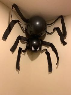 a black spider sculpture hanging from the ceiling