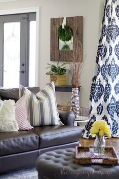 a living room filled with lots of furniture and flowers on top of a coffee table