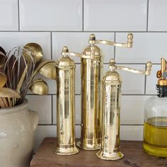 gold kitchen utensils are sitting on a counter