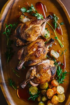 roasted chicken with vegetables and sauce on a wooden platter, ready to be eaten