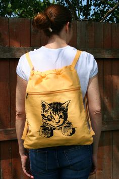 Cat Canvas Backpack A sweet, little, kitty cat backpack that you can take everywhere you go! Awww... Your kitty has been printed on a khaki, 100% cotton, canvas backpack using non-toxic, water based ink. It measures 14 ½ inches wide by 17 ½ inches tall, with cotton webbing, non-adjustable, straps. There is one large main compartment and a front zippered pocket. A great bag for carrying school books or anything you need for a day at the beach. Just the right size for your laptop too! Available in Casual Everyday Backpack With Cat Design, Everyday Cat Design Standard Backpack, Cute Everyday Cotton Backpack, Casual Cat Design Backpack For Daily Use, Cat Design Standard Backpack For Everyday, Casual Backpack With Cat Design, Cute Cotton Backpack For Everyday Use, Everyday Backpack With Cat Design, Cute Cotton Backpack For Daily Use