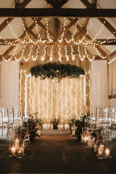 an indoor wedding venue with candles and lights