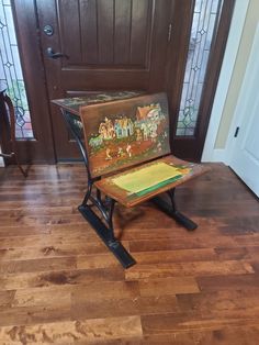 a wooden bench sitting on top of a hard wood floor in front of a door