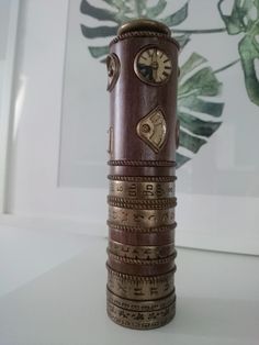 a tall wooden clock tower sitting on top of a table