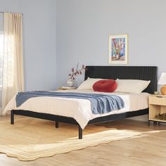 a bed room with a neatly made bed next to a night stand and nightstands