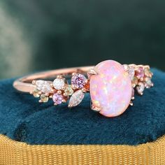 ✧ Made to Order: Handcrafted specifically for you.  ✧ Variety of Metal Options: Choose from 925 sterling silver with gold plating, or opt for 14k or 18k solid gold.  ✧ Customizations Available: Personalize every detail to make it uniquely yours.  Embrace the beauty of this vintage pink opal engagement ring! It features a captivating oval pink opal at its center, displaying a stunning play of iridescent colors that evoke a sense of ethereal beauty. Flanking the opal are delicate accents of pink sapphires, moissanite and vibrant peridot (August Birthstone), which create a charming contrast and enhance the overall design. This opal ring showcases intricate detailing with flowing lines and various shapes, reminiscent of natural elements. Crafted in 14K rose gold, the warm hues of the metal com