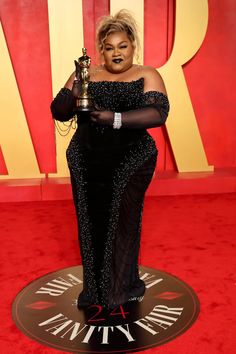 the actress poses with her award for best performance in a supporting role on stage at the oscars