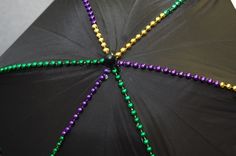 a black umbrella with beads on it