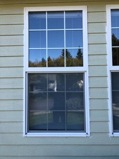 two windows on the side of a house