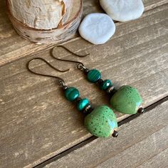 Heart earrings Malachite ceramic green earrings dangle boho earrings handmade antique bronze earrings gift unique jewelry for women Length: 40mm These beauties have 14mm handmade green ceramic kiln fired heart beads, 6mm-8mm malachite genuine stone beads, Celtic Bali beads, bronze findings and ear wires. Handmade and hammered. Unique boho earrings from SLDbeadwork. Earrings for women. Yes, please. I love to rock a great pair of earrings. Stone, crystal, lampwork, beaded earrings, well I love all Ceramic Kiln, Earrings Ceramic, Earrings Stone, Hippy Gifts, Bronze Earrings, Celtic Jewelry, Stone Crystal, Green Earrings, Amethyst Earrings