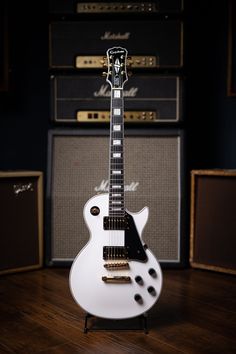 an electric guitar sitting on top of a wooden floor