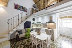 a living room and kitchen area with stairs