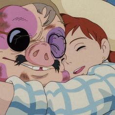 two people laying in bed next to each other and one has a pig on his head