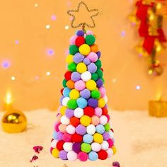 a small christmas tree made out of pom - poms