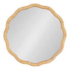 a round mirror that is made out of wicker