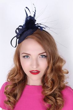 "\"Arianna\" Navy Blue Fascinator This season, sophisticated fascinators stole the show on the runways. Fascinators can be a little intimidating. But this cute little fascinator will help you overcome that fear. It perfectly lands the look, thanks to its mesh sinamay, frilly feathers, and loopy mesh ribbons. No matter the occasion, you will fit in with the fascinator craze with this simple yet stylish head-piece. Add Men's Matching Bow Tie: Don't you dare get caught mismatching your sweetie's fa Elegant Headband Fascinator For Costume Party, Elegant Mini Hat Headband For Costume Party, Elegant Mini Hat With Headband For Costume Party, Elegant Fascinator For Royal Ascot Costume Party, Elegant Fascinator For Costume Party At Royal Ascot, Elegant Headpieces For Kentucky Derby Costume Party, Elegant Mini Hats For Kentucky Derby Costume Party, Chic Blue Fascinator For Races, Blue Spring Fascinator For Formal Occasions