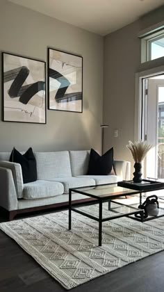 a living room filled with furniture and pictures on the wall above it's coffee table