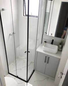 a bathroom with a sink, toilet and shower stall